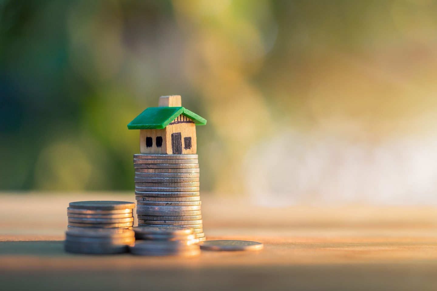 House placed on coins. planning savings money of coins to buy a home concept, concept for property ladder, mortgage and real estate investment. for saving or investment for a house.