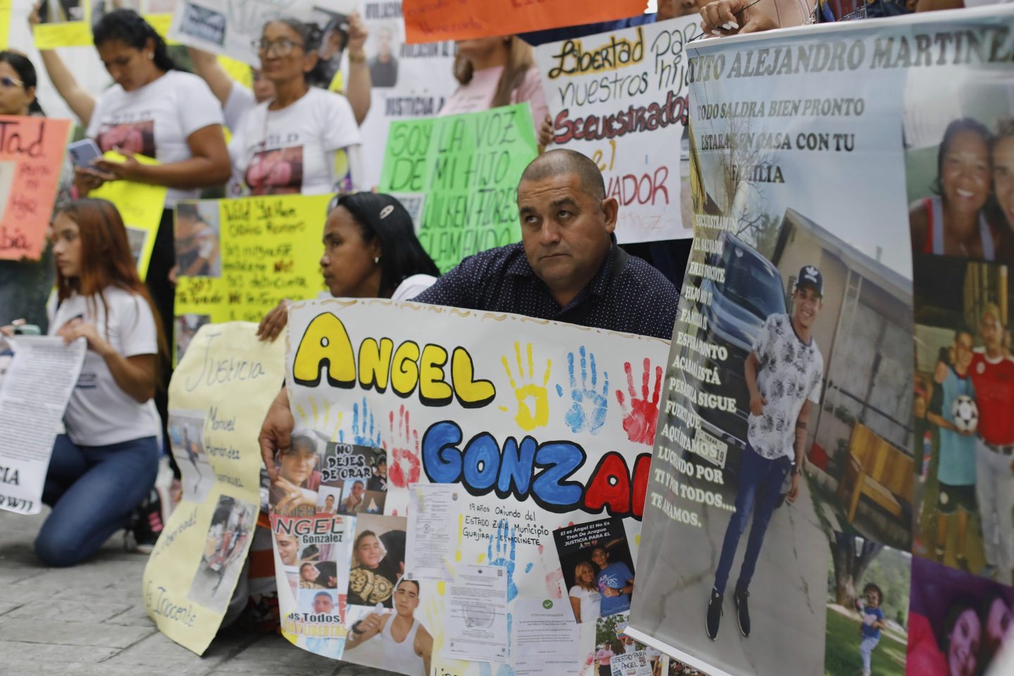 Relatives of Venezuelan migrants in the U.S. who were flown to a prison in El Salvador by the U.S. government, which alleged they were members of the Tren de Aragua gang, protest outside the United Nations building in Caracas, Venezuela, Tuesday, April 22, 2025. (AP Photo/Cristian Hernandez)